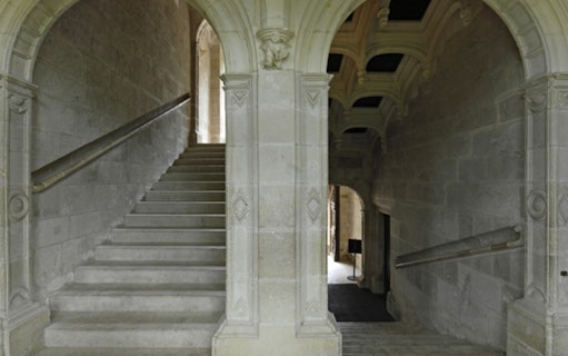 Grand staircase with stone arches at Azay-le-Rideau, France.
