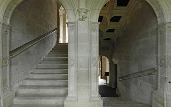 Grand staircase with stone arches at Azay-le-Rideau, France.