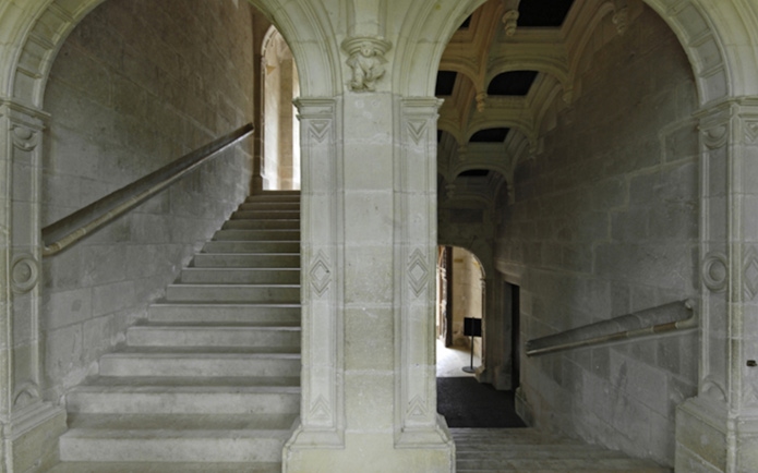 Grand staircase with stone arches at Azay-le-Rideau, France.