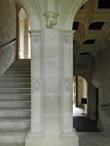 Grand staircase with stone arches at Azay-le-Rideau, France.