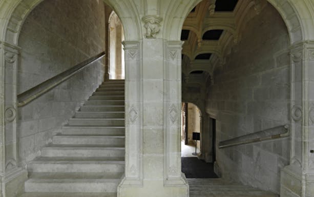 Grand staircase with stone arches at Azay-le-Rideau, France.