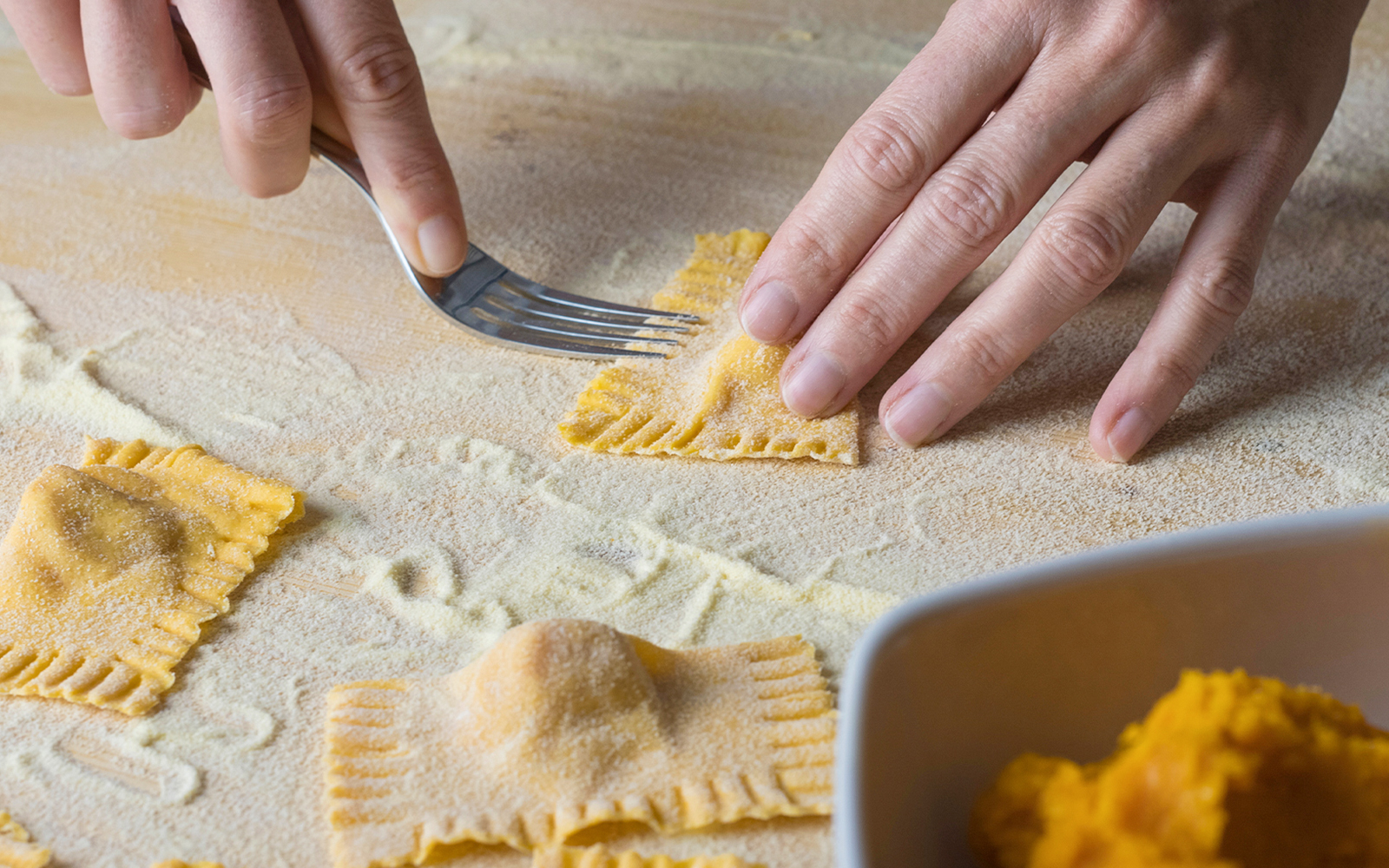 Ravioli being shaped with a fork during a cooking class in Rome.