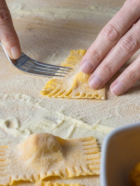 Ravioli being shaped with a fork during a cooking class in Rome.