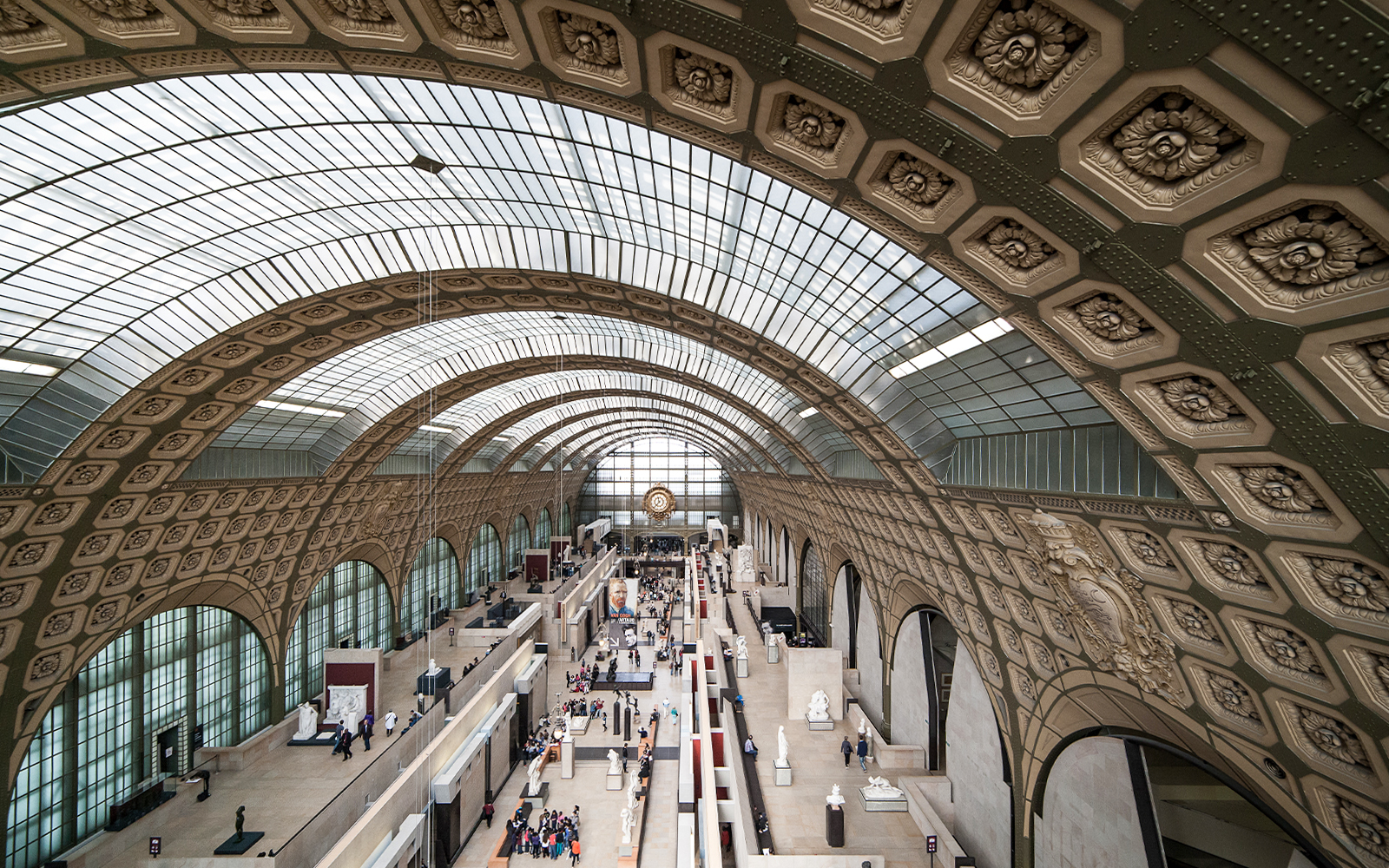 Gare d’Orsay Railway Station interior with ornate clock and arched windows, Paris.