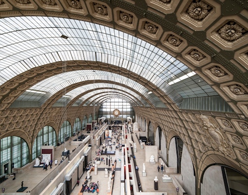 Gare d’Orsay Railway Station interior with ornate clock and arched windows, Paris.