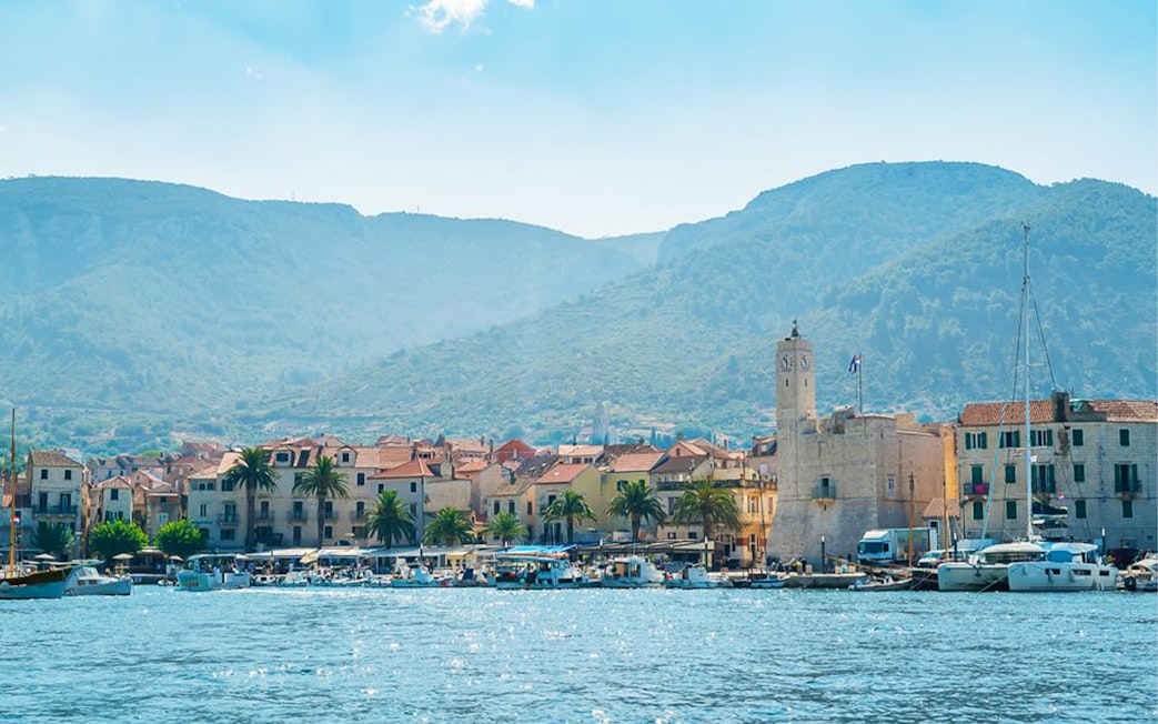 Coastal town view with boats and clock tower, Split, Croatia.