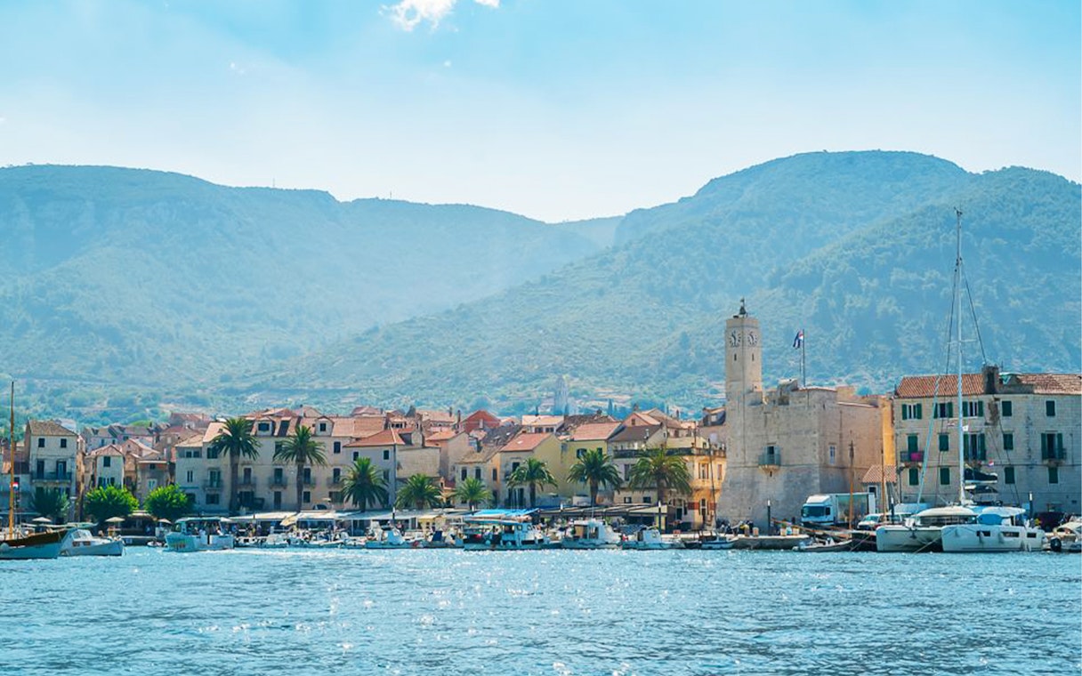 Coastal town view with boats and clock tower, Split, Croatia.