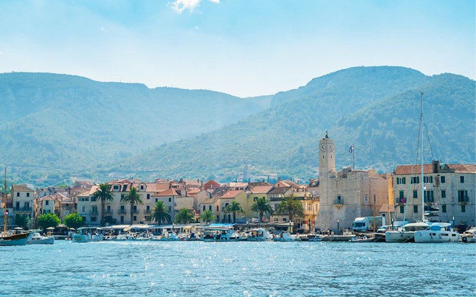 Coastal town view with boats and clock tower, Split, Croatia.