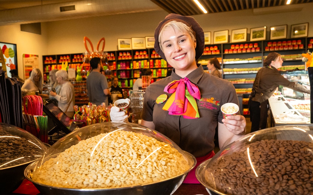 Employee at Yarra Valley chocolaterie offering chocolate samples during full day grazing tour.