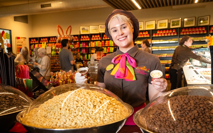 Employee at Yarra Valley chocolaterie offering chocolate samples during full day grazing tour.