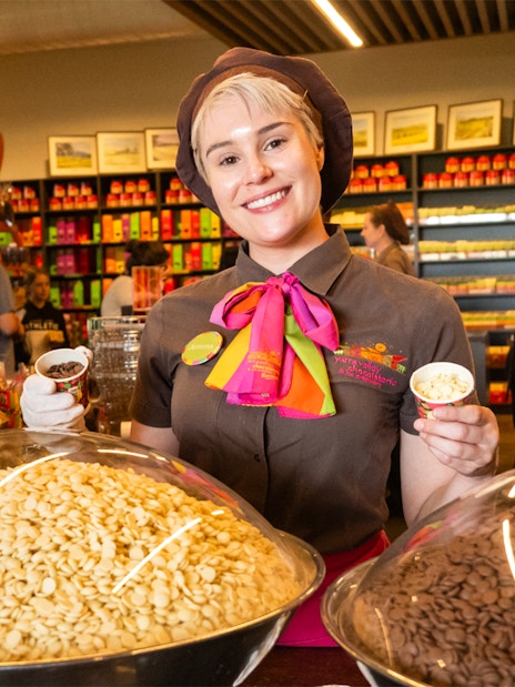 Employee at Yarra Valley chocolaterie offering chocolate samples during full day grazing tour.