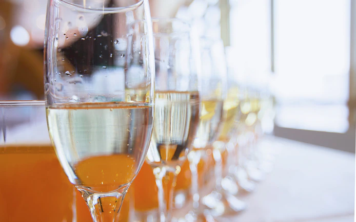 Champagne glasses lined up on a table, ready for a celebration.