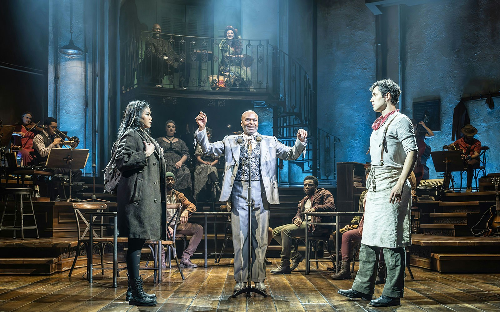 Theater performance with actors on stage, featuring a storyteller in a dramatic scene.