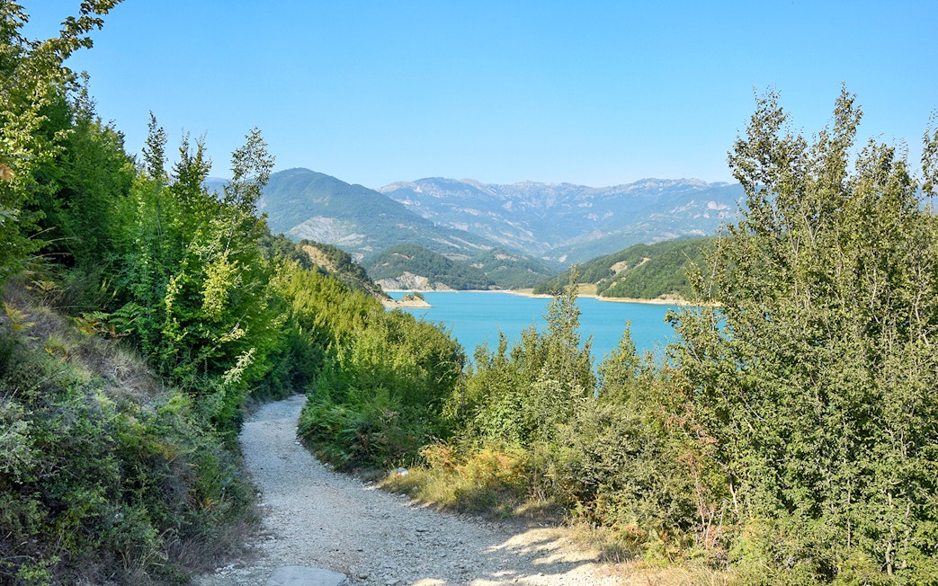 Bovilla Lake view with surrounding mountains and forested path during 4x4 offroad tour.