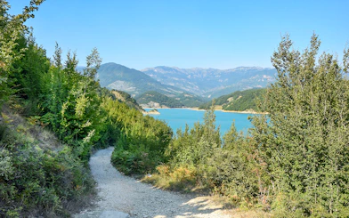 Bovilla Lake view with surrounding mountains and forested path during 4x4 offroad tour.