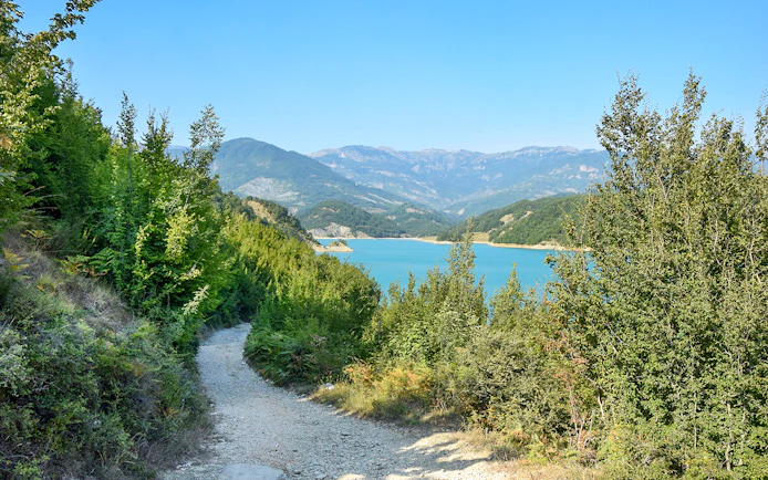 Bovilla Lake view with surrounding mountains and forested path during 4x4 offroad tour.
