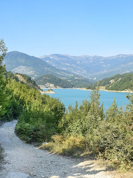 Bovilla Lake view with surrounding mountains and forested path during 4x4 offroad tour.