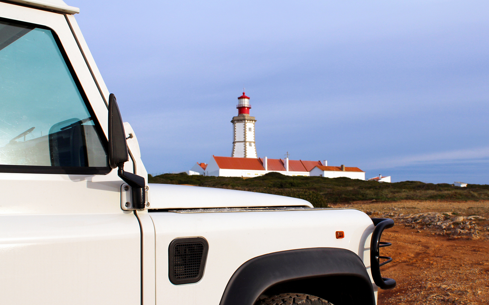 4x4 Jeep near Cape Espichel lighthouse, Portugal.