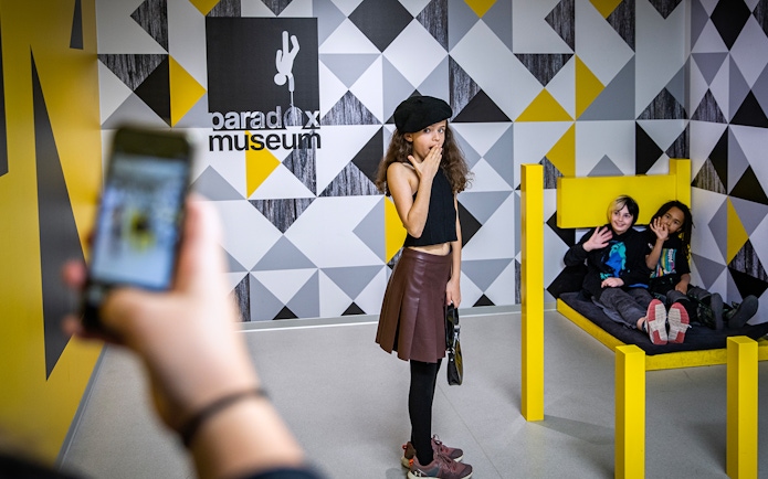 Visitors exploring interactive exhibit at Paradox Museum.
