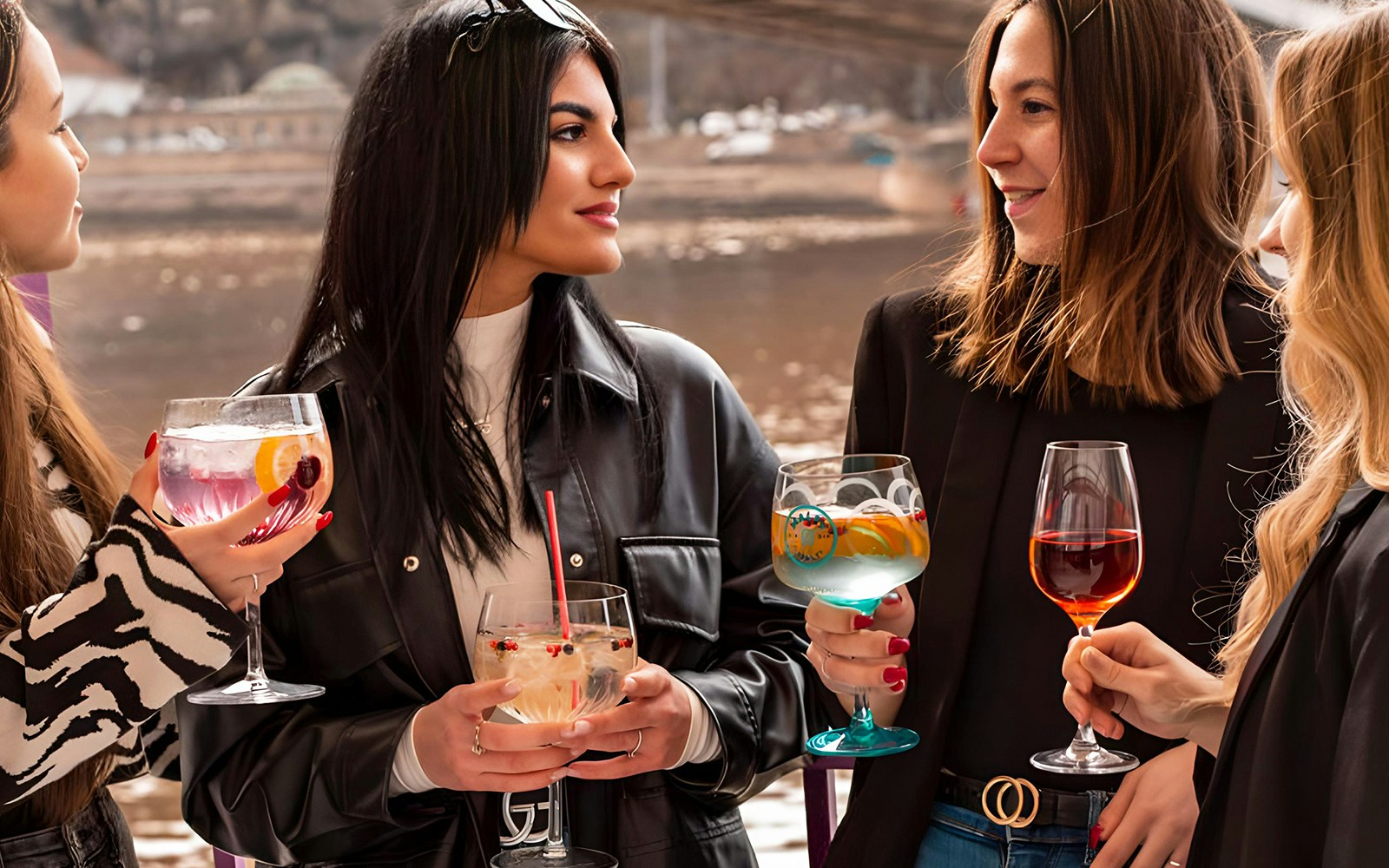 tourists enjoying Budapest river cruise with drinks.