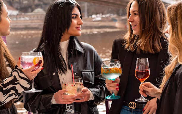 Guests enjoying drinks on a Budapest fireworks cruise.