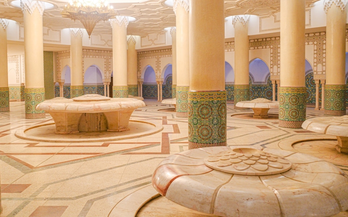 Hassan II Mosque interior with ornate columns and intricate tilework, Casablanca, Morocco.