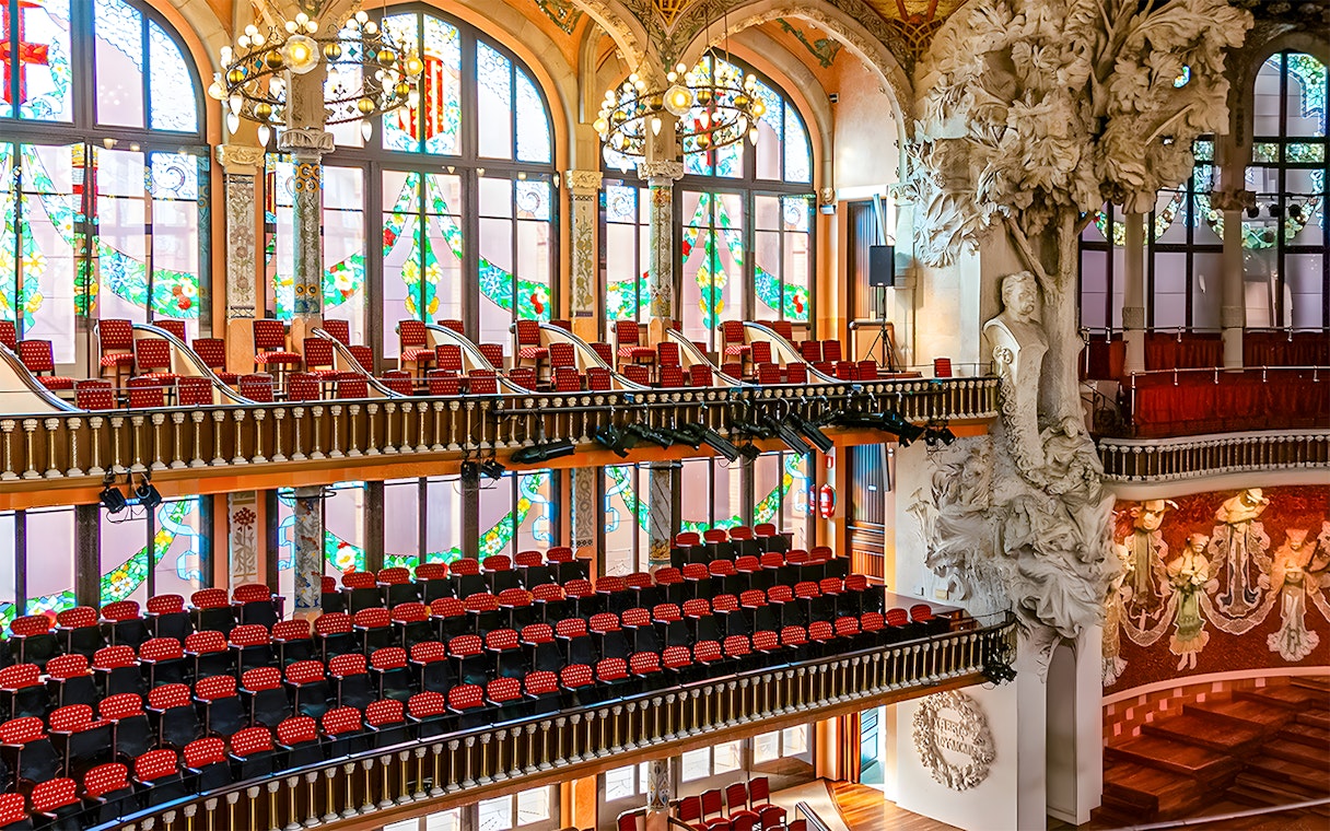 Interior of Palau de la Música Catalana with stained glass windows and ornate sculptures, Barcelona.