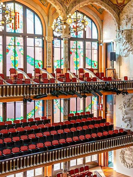 Interior of Palau de la Música Catalana with stained glass windows and ornate sculptures, Barcelona.