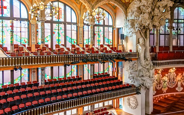 Interior of Palau de la Música Catalana with stained glass windows and ornate sculptures, Barcelona.
