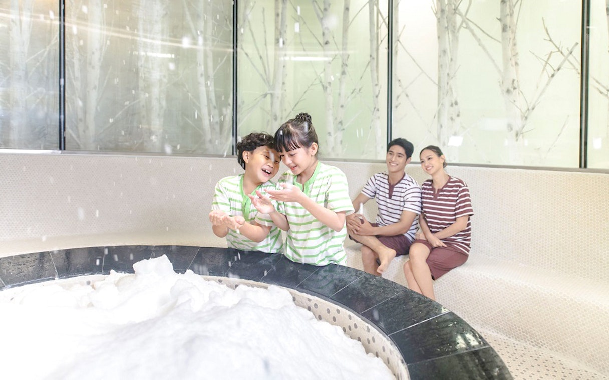 Family enjoying snow room at Aquafield Nha Trang, Vietnam.