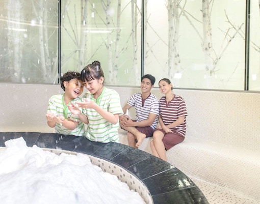 Family enjoying snow room at Aquafield Nha Trang, Vietnam.