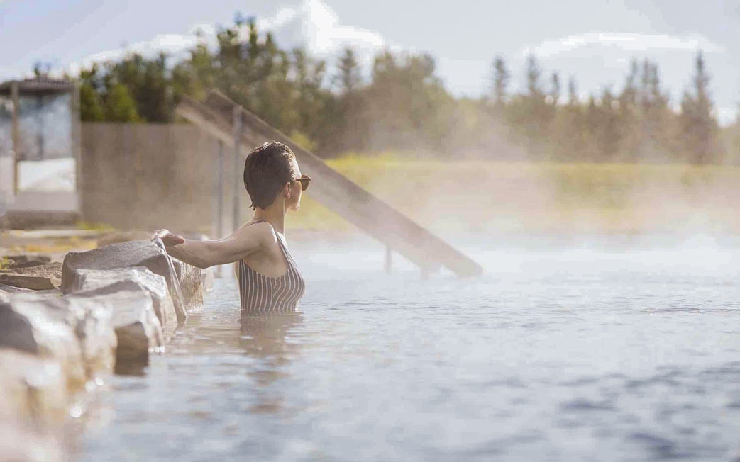 Guests enjoying the warm waters of Secret Lagoon Gamla Laugin in Iceland.