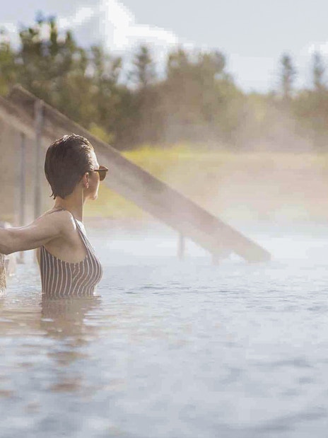 Guests enjoying the warm waters of Secret Lagoon Gamla Laugin in Iceland.