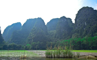 Trang An Landscape Complex with limestone karsts and lush greenery in Vietnam.