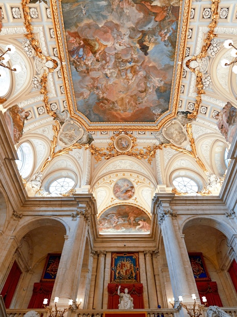 Ceiling fresco and ornate architecture inside the Royal Palace of Madrid.