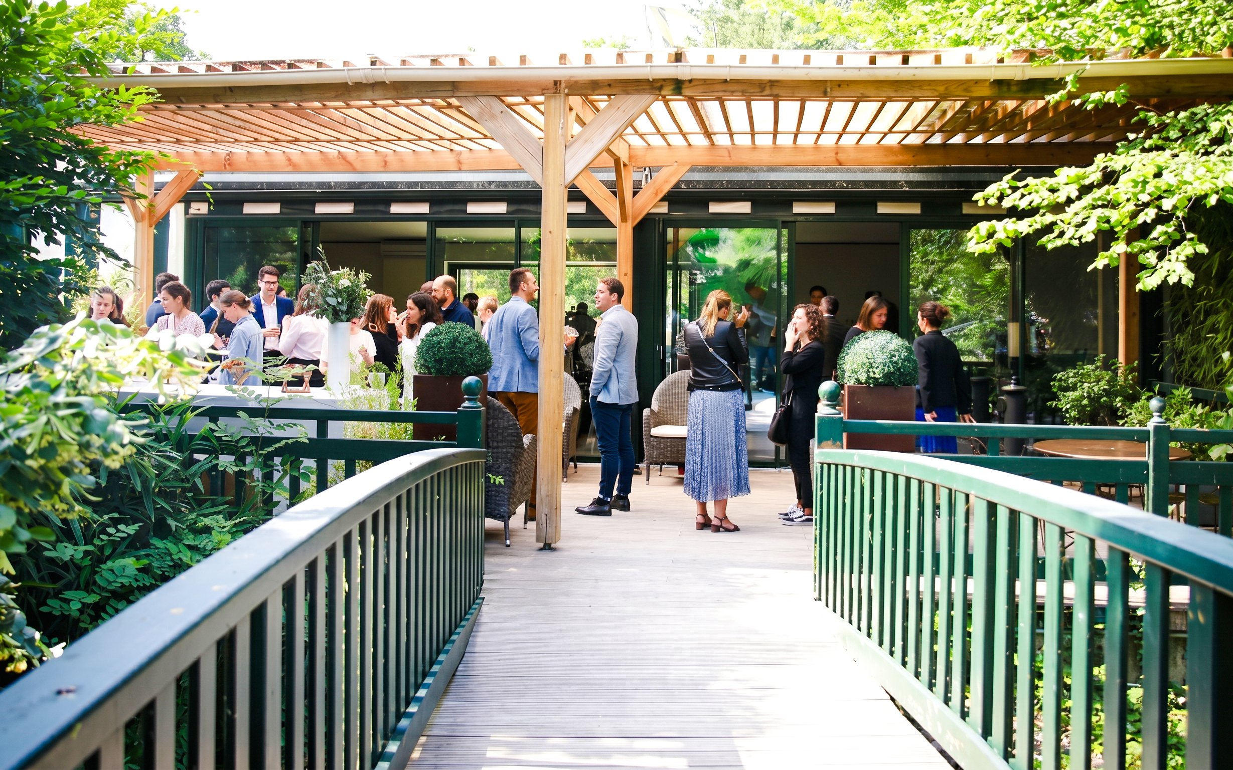 Visitors gathering on a terrace at Jardin d'Acclimatation, Paris.
