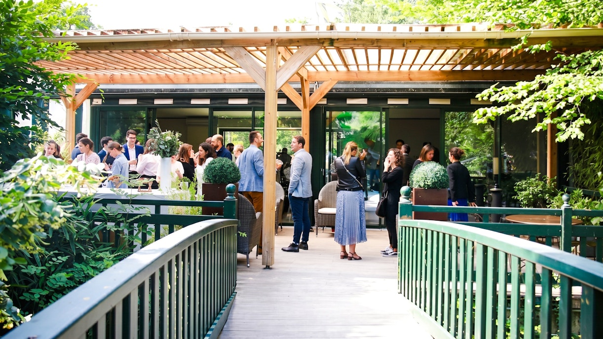 Visitors gathering on a terrace at Jardin d'Acclimatation, Paris.
