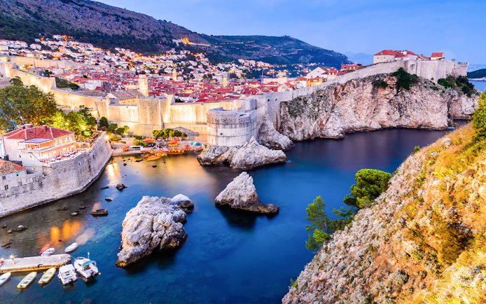 Dubrovnik city walls and coastline at sunset, Croatia.