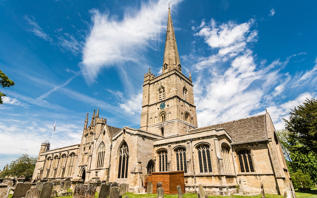 St. John the Baptist Church in Burford with its tall spire and historic architecture.
