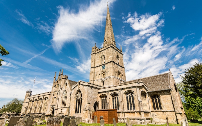 St. John the Baptist Church in Burford with its tall spire and historic architecture.