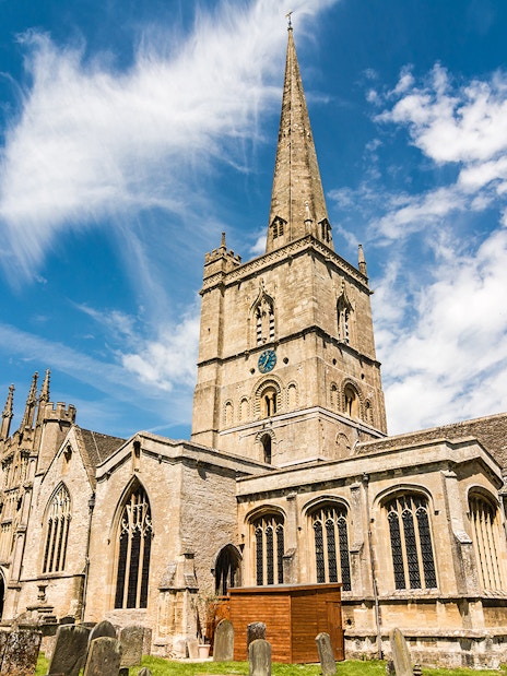 St. John the Baptist Church in Burford with its tall spire and historic architecture.