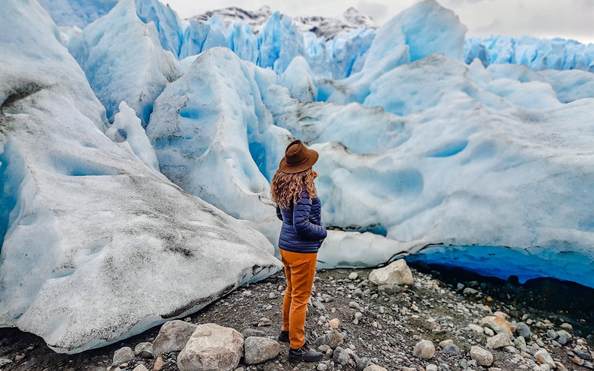 Person observing large blue glacier on Copia de Safari Azul tour.