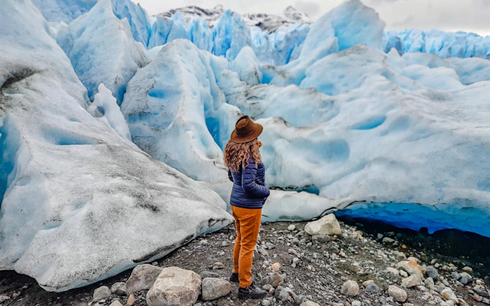 Person observing large blue glacier on Copia de Safari Azul tour.