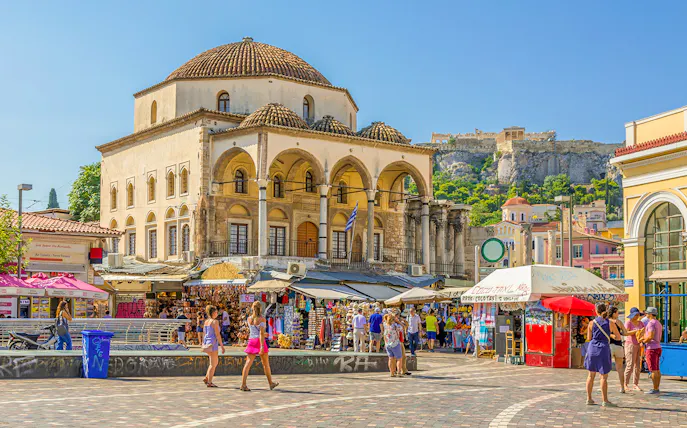 Monastiraki Square market with Tzistarakis Mosque and Acropolis in Athens.