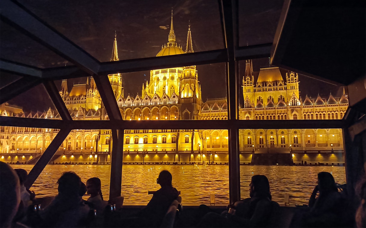 Hungarian Parliament Building illuminated at night viewed from a Budapest Danube River dinner cruise.