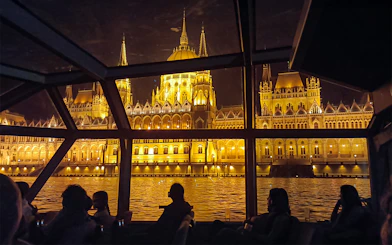 Hungarian Parliament Building illuminated at night viewed from a Budapest Danube River dinner cruise.