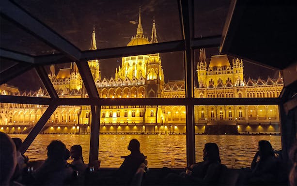 Hungarian Parliament Building illuminated at night viewed from a Budapest Danube River dinner cruise.