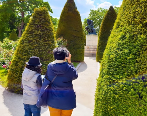Exclusive private guided tour group exploring the Rodin Museum in Paris, admiring the unique sculptures and artwork
