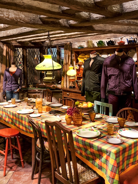 Weasley kitchen exhibit with table setting, part of Harry Potter London tour.