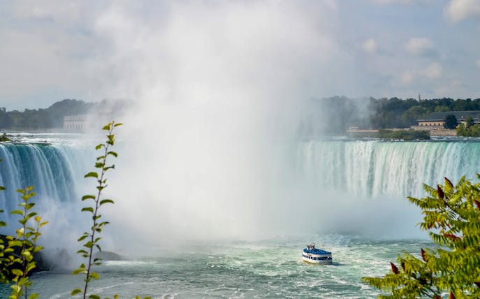Niagara Falls with tour boat in foreground, New York helicopter tour.
